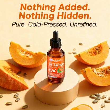 Cold-pressed pumpkin seed oil bottle with pumpkins and seeds on a light background.